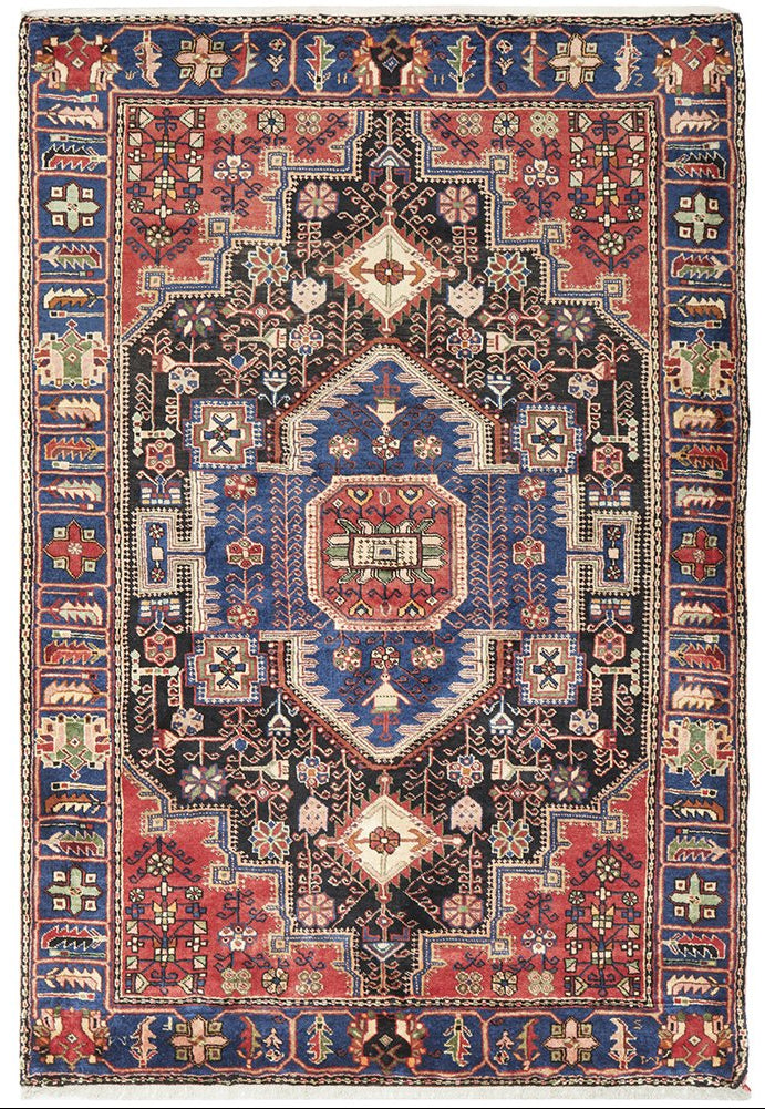 A traditional hand-knotted pure wool Nahavand rug featuring a geometric pattern with multiple colors, predominantly red and blue.