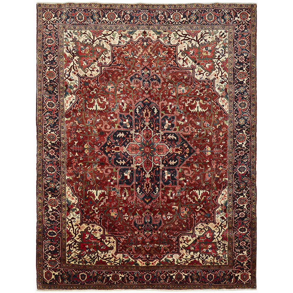A large, hand knotted Persian rug with a central geometric medallion and ivory highlights, featuring a dense pile and a cotton warp and weft.