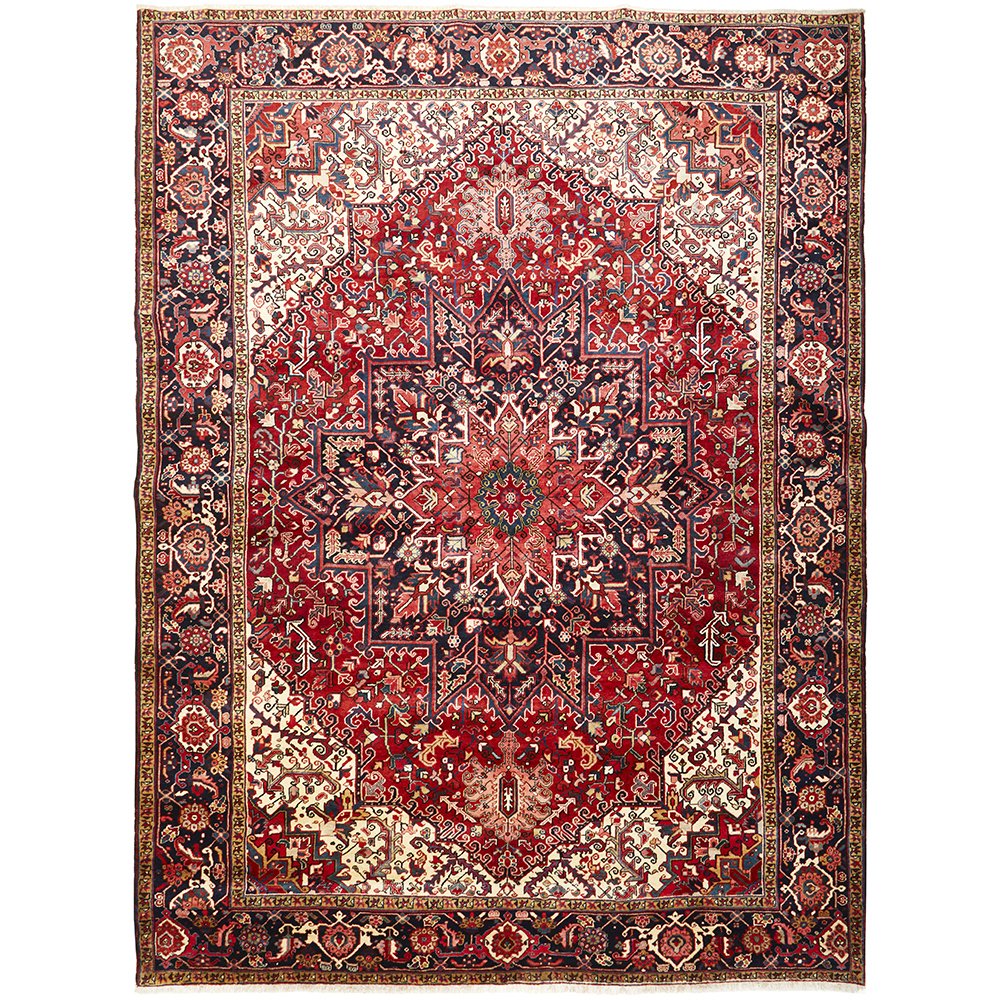 A large, hand knotted Persian rug with a geometric medallion design and ivory highlights, predominantly red and blue colors, made of wool.