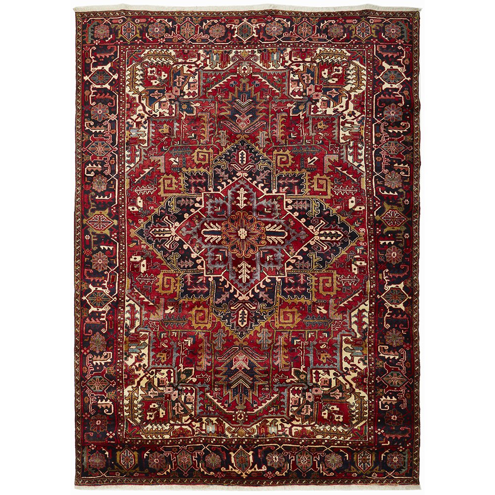 A Heriz hand knotted Persian rug featuring a geometric pattern with red, blue, and beige colors.