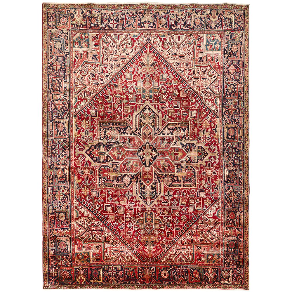 A Heriz hand knotted Persian rug with a geometric medallion design and ivory highlights.