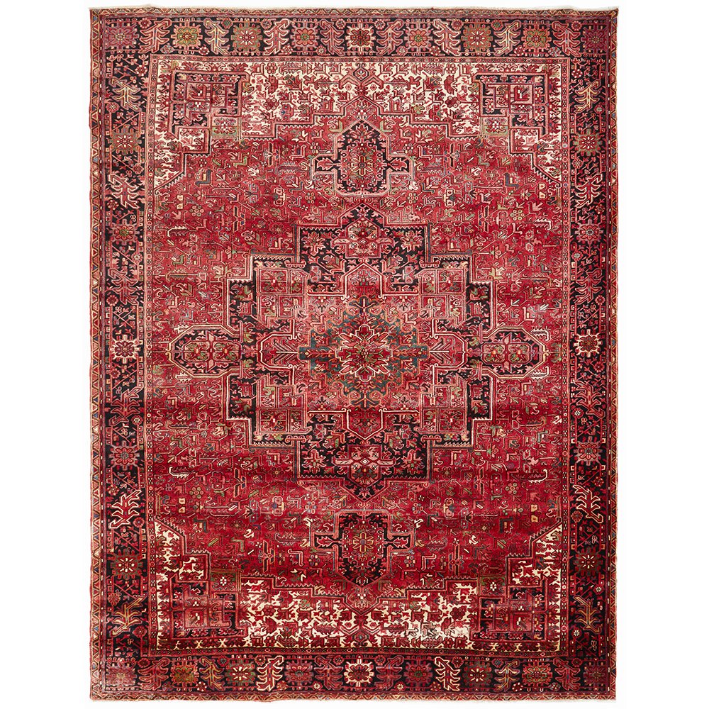 A large, hand knotted Persian rug with a geometric medallion design in the center, featuring red and dark colors with ivory highlights.