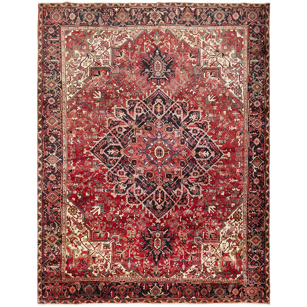 A Heriz hand knotted Persian rug with a geometric medallion design and ivory highlights on a red background.