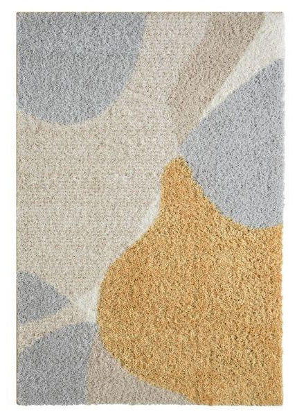 A shaggy, rectangular area rug with a multicolored design featuring shades of beige, gray, and yellow.