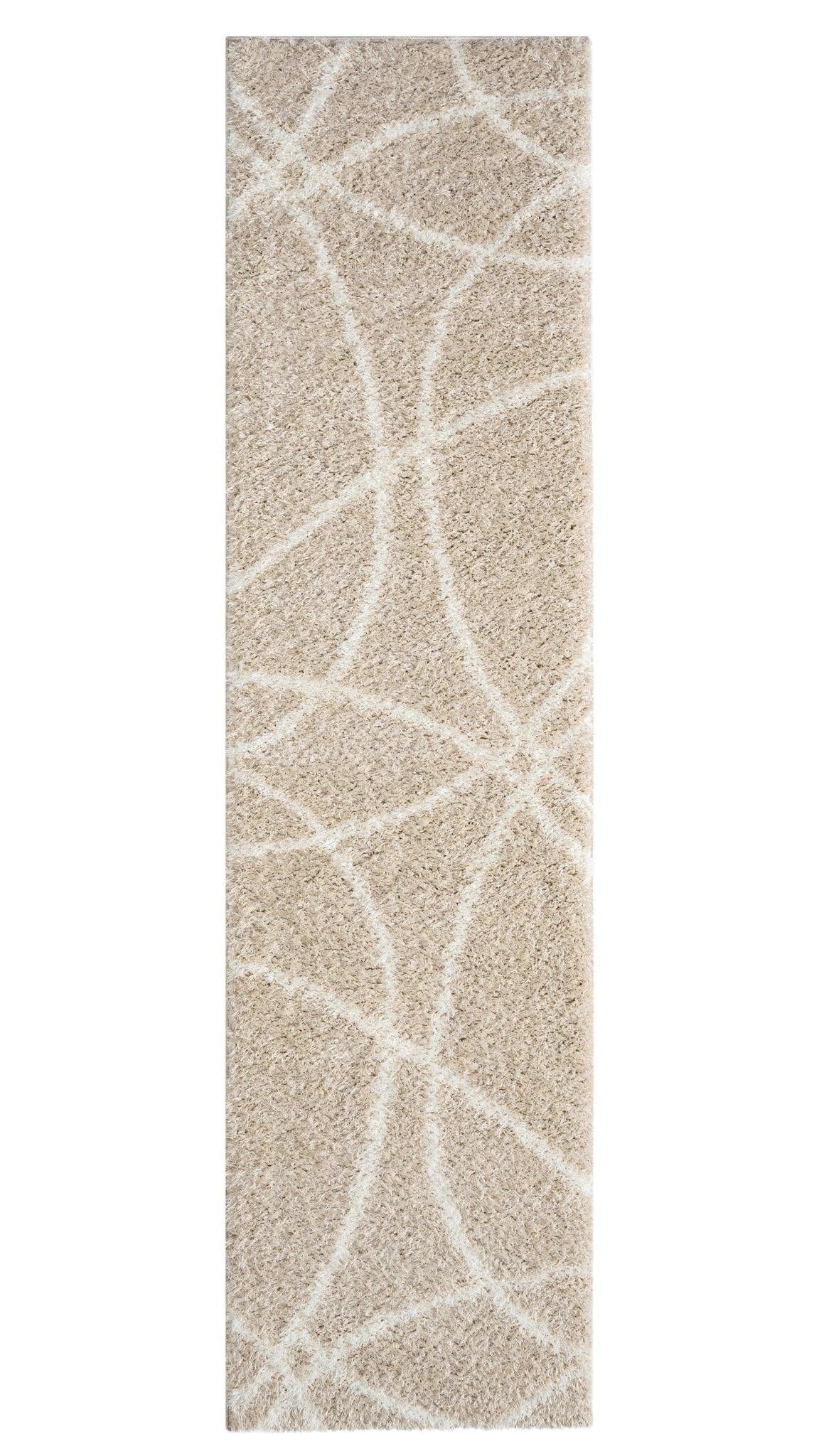 A fawn-colored shaggy runner rug with a geometric pattern, power-loomed on a polypropylene base.